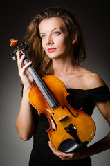 Woman performer with violin in studio