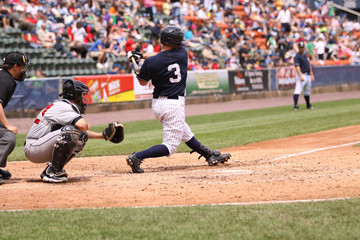 Baseball batter swinging - obrazy, fototapety, plakaty