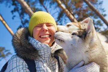 young woman emracing sled dogs