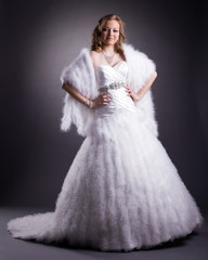 Pretty woman posing in luxurious wedding dress