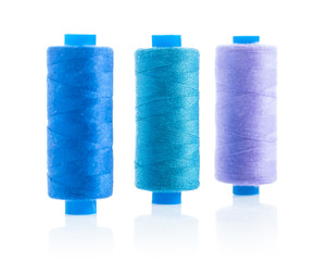 three sewing bobbins