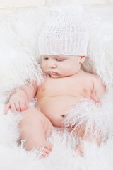 Portrait of a baby in white hat