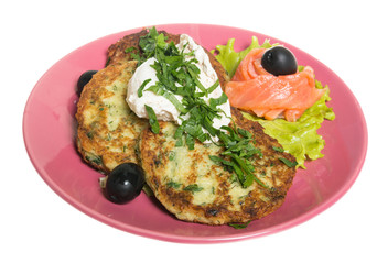 Roasted cutlets of potato with salmon on a plate