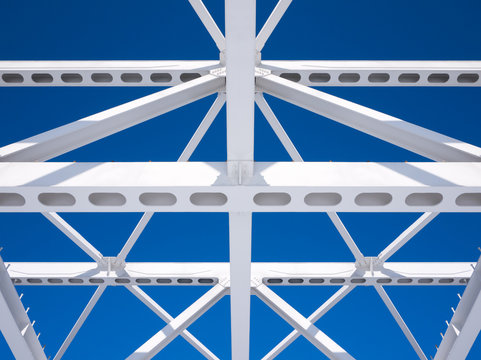 Steel beams against the blue sky. Fragment construction site.