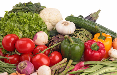 heap of raw vegetables on white