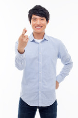 Young asian man showing lucky sign.