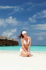 Fototapeta premium Cute woman relaxing on the beach
