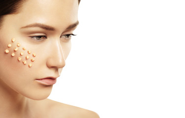 Fototapeta premium Woman applying skin foundation