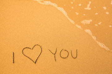 I Love You - text written by hand in sand on a beach