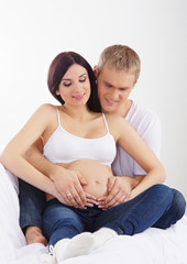 Young attractive couple: pregnant mother and happy father