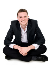 Young businessman sitting on the floor
