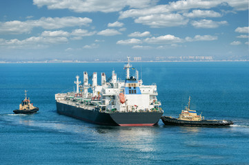 cargo ship and tug boat