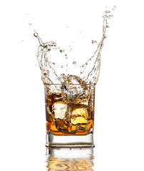 Whiskey glass with splash, isolated on white background