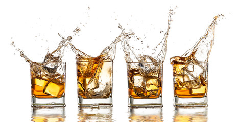 Whiskey glasses with splash, isolated on white background