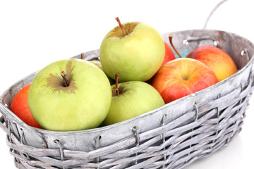 Ripe apples in basket isolated on white