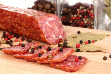 Tasty sausage on chopping board close-up