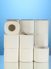 Rolls of toilet paper on blue background