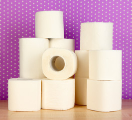 Rolls of toilet paper on purple with dots background