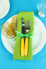 Knife and fork wrapped in napkin,