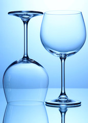 Empty wine glasses arranged on blue background