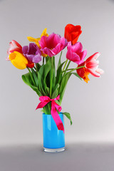Beautiful tulips in bouquet on gray background