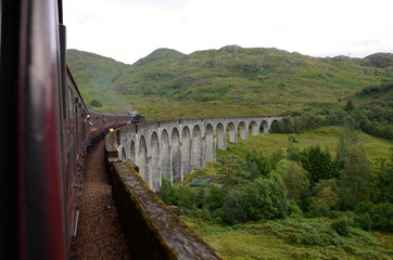Fototapeta na wymiar Jacobite steam train crossing Glenfinnan viaduct