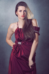 Fashion model posing with elegant red dress