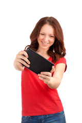 Naklejka premium Young woman playing games on tablet