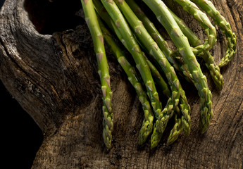 Bunch of fresh asparagus on a wooden table.