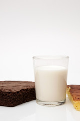 glass of milk with different biscuits