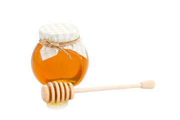 honey in glass pot and stick