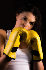 Young sporty female with boxing gloves