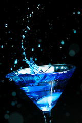 blue splashing cocktail on black