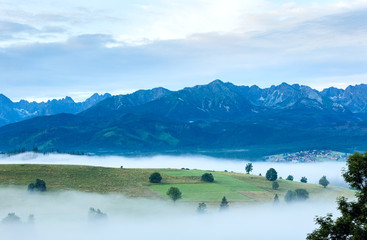 Sunrise and summer misty mountain country view