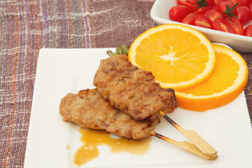 roast pork on a plate with red tomato