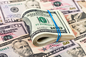 Stack of one hundred dollar bills row on money background