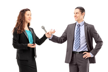 A businesswoman and male reporter having an interview