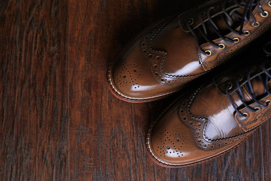 luxury brown shoes on wood background.