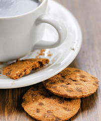 Coffee and oatmeal cookies on wooden table