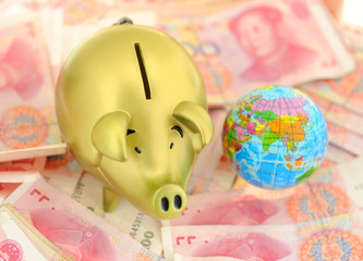 piggy bank and one-hundred rmb bill