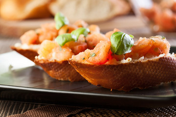 Bruschetta with mozzarella and tomato. Selective focus