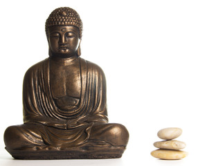 Fototapeta premium Buddha in Meditation next to a pile of Stones