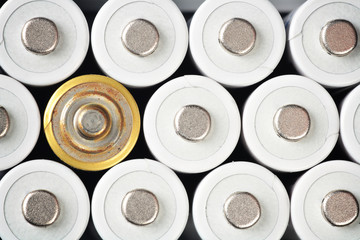 White rechargeable AA batteries and a rusty one