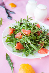 salad of fresh greens and slices of grapefruit