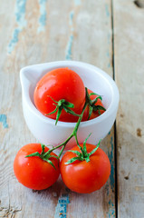 Fresh tomatoes in a white bowl