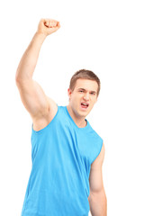 Young euphoric sportsman with raised hand gesturing happiness