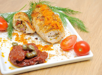 Chicken rolls and vegetables on the plate