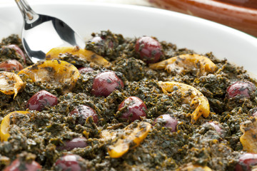 Moroccan spinach with lemon and olives closeup
