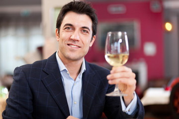 Man toasting wine in a restaurant