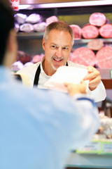 Shopkeeper serving a customer in a grocery store